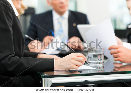 stock-photo-business-meeting-in-an-office-lawyers-or-attorneys-discussing-a-document-or-contract-agreement-98297690